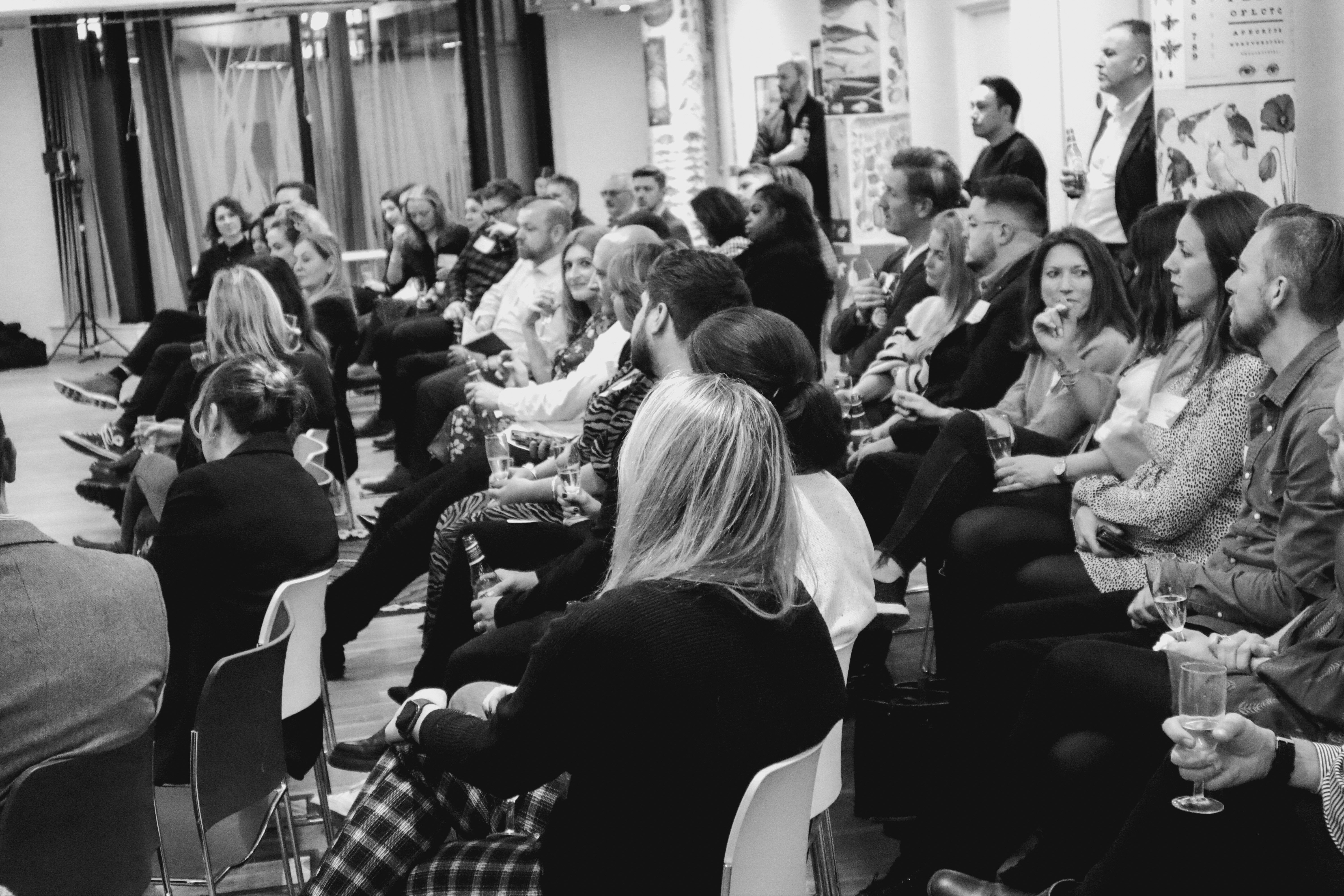 Elevate attendees seated and listening to conversation