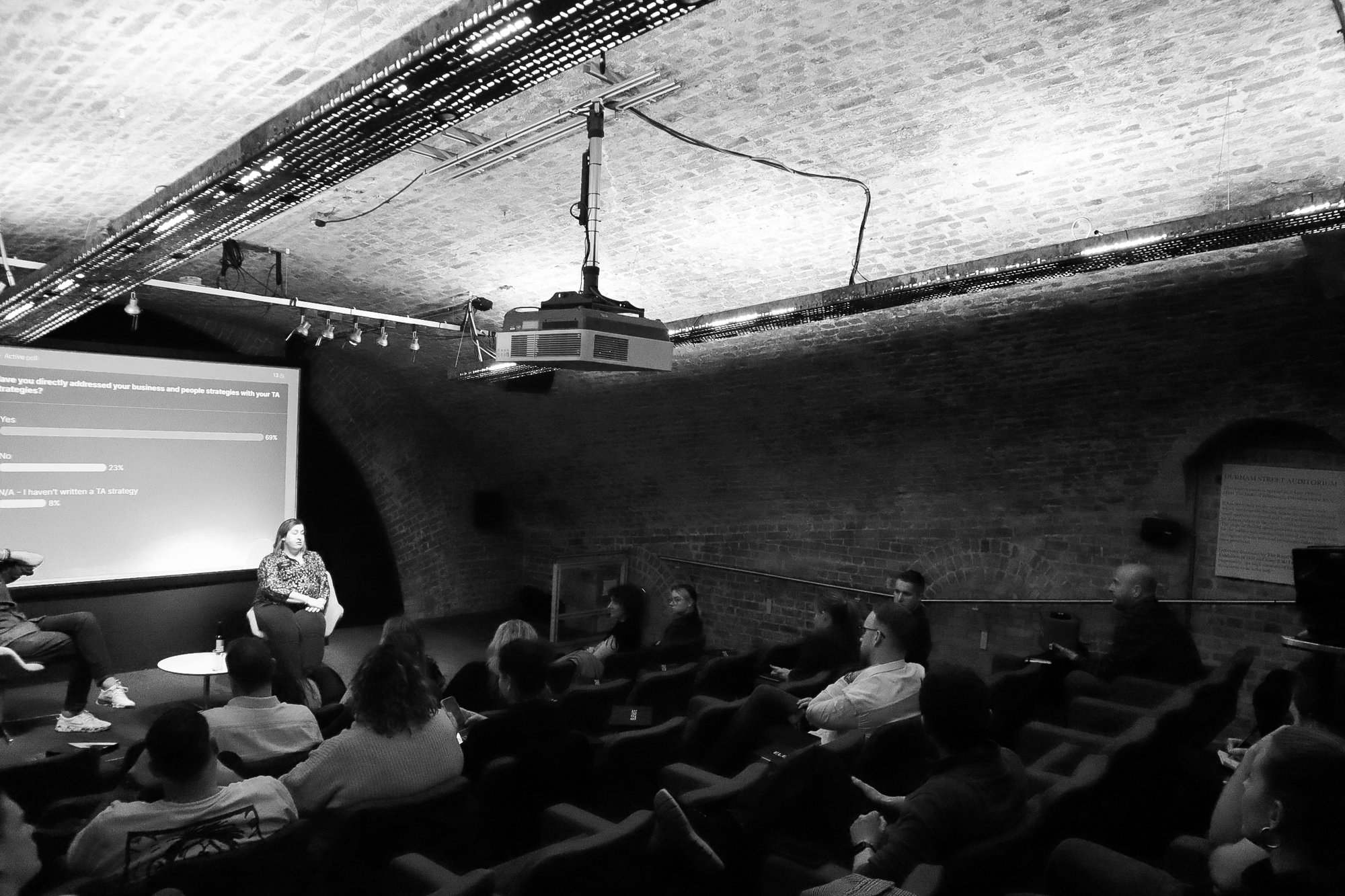A wide view of the rows of attendees in the room at Elevate